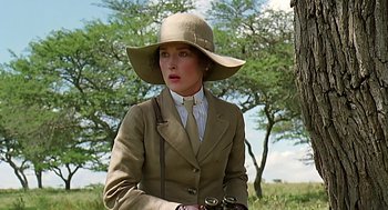 Movie still from “Out of Africa” (1985), directed by Sydney Pollack – A woman wearing a hat and holding a binoculars; Close Up shot, Low angle