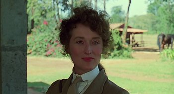 Movie still from “Out of Africa” (1985), directed by Sydney Pollack – A person wearing a suit and tie; Close Up shot, Low angle