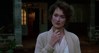Movie still from “Out of Africa” (1985), directed by Sydney Pollack – A woman in a white shirt and a beige sweater; Close Up shot, Over the shoulder angle