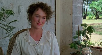 Movie still from “Out of Africa” (1985), directed by Sydney Pollack – A woman in a white shirt is smiling for the camera; Close Up shot, Over the shoulder angle