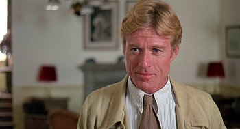 Movie still from “Out of Africa” (1985), directed by Sydney Pollack – A person wearing a suit and tie; Close Up shot, Low angle