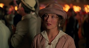 Movie still from “Out of Africa” (1985), directed by Sydney Pollack – A woman wearing a hat and a jacket; Close Up shot, Over the shoulder angle