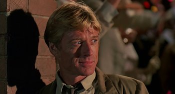 Movie still from “Out of Africa” (1985), directed by Sydney Pollack – A person wearing a suit and tie; Close Up shot, Low angle