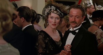 Movie still from “Out of Africa” (1985), directed by Sydney Pollack – A man and a woman dressed in formal wear; Close Up shot, Low angle