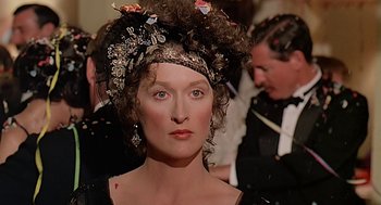 Movie still from “Out of Africa” (1985), directed by Sydney Pollack – A person wearing a dress; Close Up shot, Over the shoulder angle