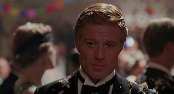 Movie still from “Out of Africa” (1985), directed by Sydney Pollack – A person wearing a suit and bow tie; Close Up shot, Over the shoulder angle