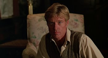 Movie still from “Out of Africa” (1985), directed by Sydney Pollack – A person sitting in a chair; Close Up shot, Low angle