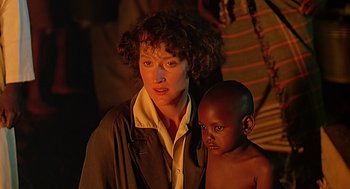 Movie still from “Out of Africa” (1985), directed by Sydney Pollack – A woman standing next to a young boy; Close Up shot, Over the shoulder angle