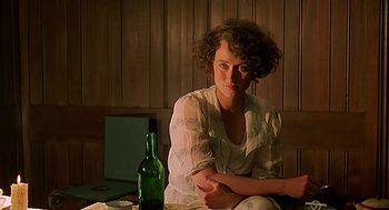 Movie still from “Out of Africa” (1985), directed by Sydney Pollack – A woman sitting in front of a bottle of wine; Close Up shot, Over the shoulder angle
