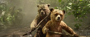 Movie still from “Paddington” (2014), directed by Paul King – A couple of brown bears in the water with sticks; Wide shot, Low angle