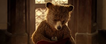 Movie still from “Paddington” (2014), directed by Paul King – A teddy bear sitting in front of a window holding a guitar; Close Up shot, Low angle