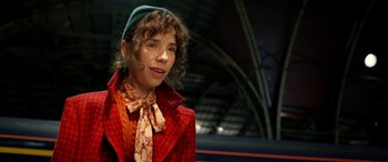 Movie still from “Paddington” (2014), directed by Paul King – A woman in a red coat and a blue hat; Close Up shot, Over the shoulder angle