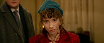 Movie still from “Paddington” (2014), directed by Paul King – A woman wearing a blue hat and a polka dot shirt; Close Up shot, High angle