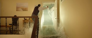 Movie still from “Paddington” (2014), directed by Paul King – A man standing on top of a wooden stair railing; Wide shot, High angle