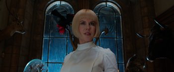 Movie still from “Paddington” (2014), directed by Paul King – A woman in a white shirt standing in front of a stained glass window; Close Up shot, Low angle