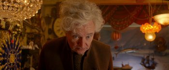 Movie still from “Paddington” (2014), directed by Paul King – An older man with a curly white hair and blue eyes; Close Up shot, Over the shoulder angle