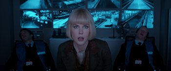 Movie still from “Paddington” (2014), directed by Paul King – A woman with blonde hair sitting in front of a screen; Close Up shot, Over the shoulder angle