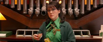 Movie still from “Paddington” (2014), directed by Paul King – A woman in a green shirt holding a can of food; Medium shot, Low angle