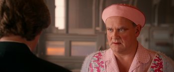 Movie still from “Paddington” (2014), directed by Paul King – An older woman wearing a pink hat and a pink jacket; Close Up shot, Over the shoulder angle