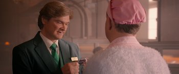 Movie still from “Paddington” (2014), directed by Paul King – A man wearing a green tie and a green suit; Close Up shot, Over the shoulder angle