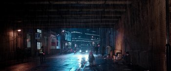 Movie still from “Paddington” (2014), directed by Paul King – A city street at night under a bridge; Extreme Wide shot, High angle
