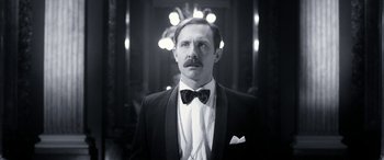 Movie still from “Paddington” (2014), directed by Paul King – A man in a suit and bow tie; Close Up shot, Low angle