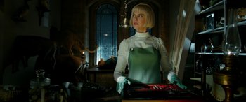 Movie still from “Paddington” (2014), directed by Paul King – A woman in a green apron standing in front of a window; Medium shot, Low angle