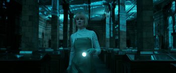 Movie still from “Paddington” (2014), directed by Paul King – A woman standing in a room holding a flashlight; Medium shot, Low angle