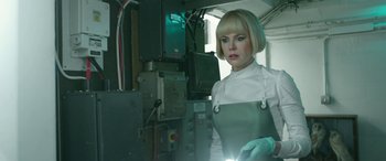 Movie still from “Paddington” (2014), directed by Paul King – A woman with short blonde hair wearing a lab coat; Medium shot, Low angle