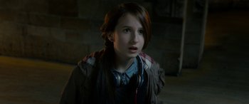 Movie still from “Paddington” (2014), directed by Paul King – A young girl wearing a jacket and headphones looking up; Close Up shot, Over the shoulder angle