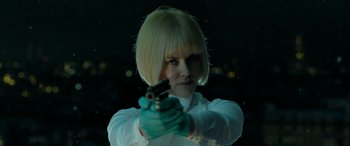 Movie still from “Paddington” (2014), directed by Paul King – A woman with blonde hair is holding a gun; Close Up shot, Low angle