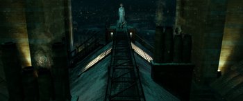 Movie still from “Paddington” (2014), directed by Paul King – A man standing on a bridge at night; Wide shot, Low angle