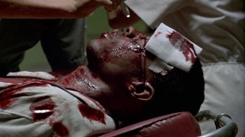 Movie still from “Paid in Full” (2002), directed by Charles Stone III – A man with blood all over his face and head; Close Up shot, High angle