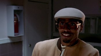 Movie still from “Paid in Full” (2002), directed by Charles Stone III – A person wearing glasses and a hat; Close Up shot, Low angle