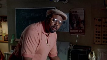 Movie still from “Paid in Full” (2002), directed by Charles Stone III – A man in a pink shirt and a tan hat; Medium shot, Over the shoulder angle