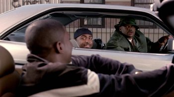 Movie still from “Paid in Full” (2002), directed by Charles Stone III – A group of men sitting in the back seat of a car; Medium shot, Over the shoulder angle