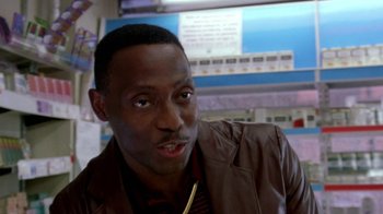 Movie still from “Paid in Full” (2002), directed by Charles Stone III – A person wearing a brown jacket; Close Up shot, Over the shoulder angle