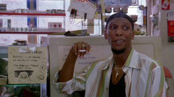 Movie still from “Paid in Full” (2002), directed by Charles Stone III – A man holding a cigarette in front of a whiteboard; Close Up shot, Low angle