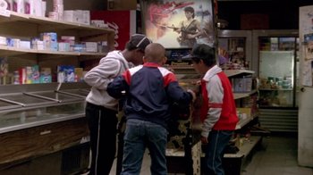 Movie still from “Paid in Full” (2002), directed by Charles Stone III – A group of young men standing next to each other in a store; Wide shot, High angle