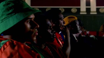 Movie still from “Paid in Full” (2002), directed by Charles Stone III – A group of men sitting next to each other in a room; Close Up shot, Low angle