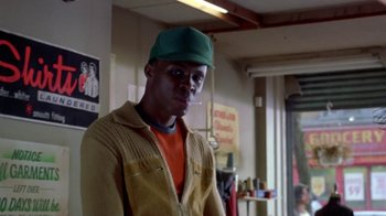 Movie still from “Paid in Full” (2002), directed by Charles Stone III – A man wearing a green hat standing in a room; Close Up shot, Low angle