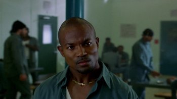 Movie still from “Paid in Full” (2002), directed by Charles Stone III – A person wearing a shirt and a necklace; Close Up shot, Over the shoulder angle