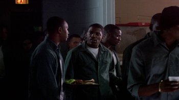 Movie still from “Paid in Full” (2002), directed by Charles Stone III – A group of men standing next to each other holding food; Medium shot, High angle