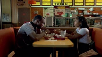 Movie still from “Paid in Full” (2002), directed by Charles Stone III – A man and a woman sitting at a table with food in front of them; Medium shot, High angle