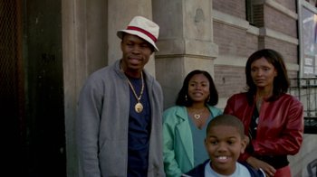 Movie still from “Paid in Full” (2002), directed by Charles Stone III – A group of people standing next to each other near a building; Medium shot, Low angle