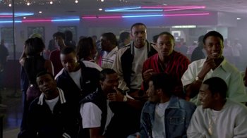 Movie still from “Paid in Full” (2002), directed by Charles Stone III – A group of young men standing in a room; Medium shot, High angle