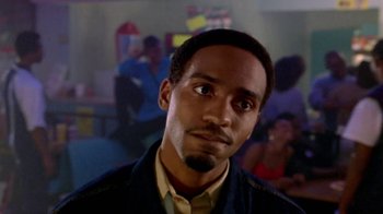 Movie still from “Paid in Full” (2002), directed by Charles Stone III – A person wearing a suit and tie; Close Up shot, Low angle