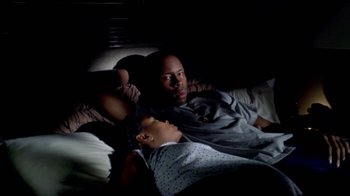 Movie still from “Paid in Full” (2002), directed by Charles Stone III – A man and a woman laying in a bed together; Medium shot, Overhead angle