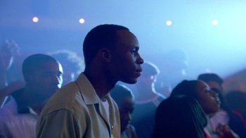 Movie still from “Paid in Full” (2002), directed by Charles Stone III – A man standing in front of a group of people; Close Up shot, Over the shoulder angle