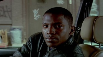 Movie still from “Paid in Full” (2002), directed by Charles Stone III – A person wearing a leather jacket; Close Up shot, Low angle